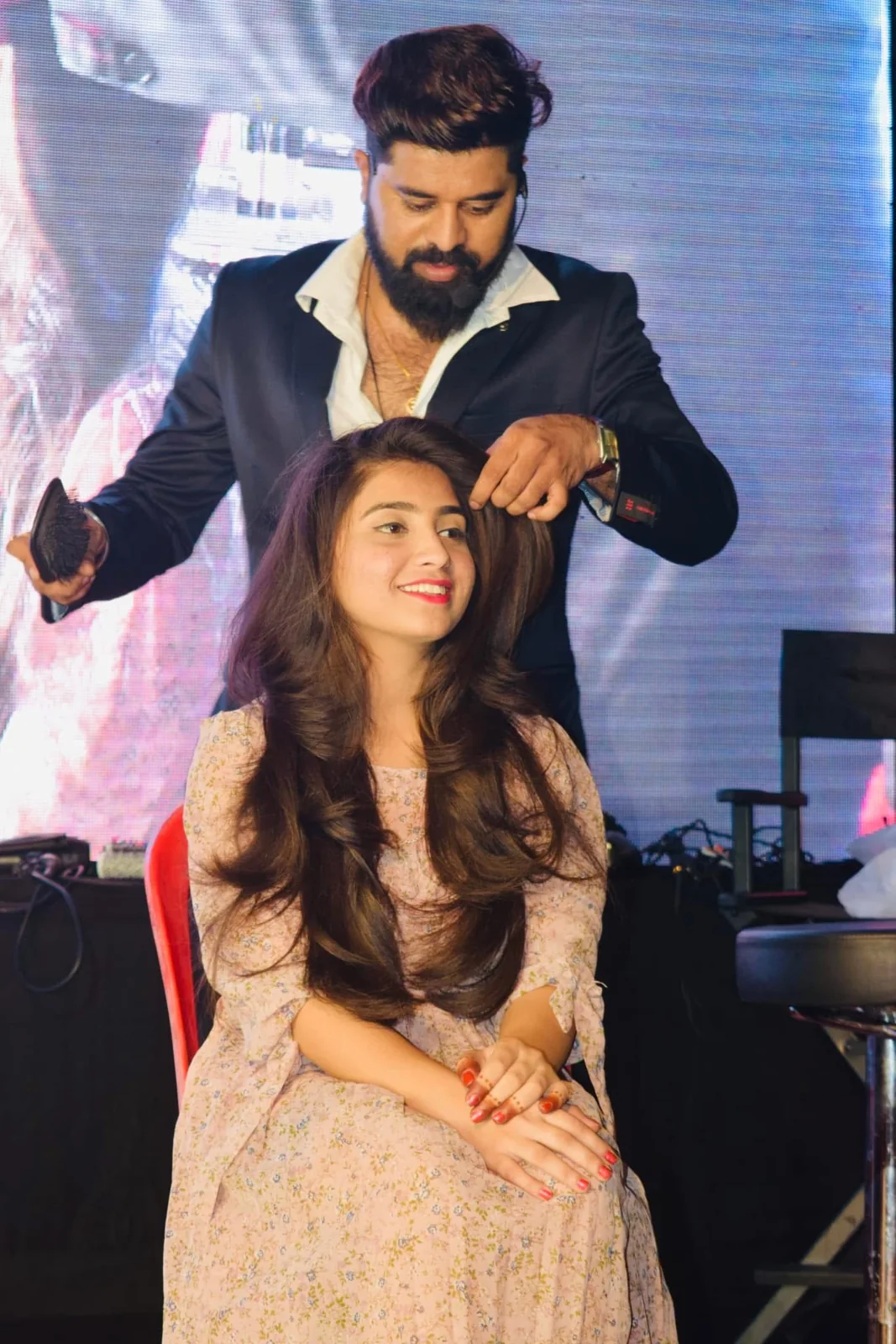 Bhavesh Bidve, Creative Head of The 7S Saloon Mall, styling hair on stage
